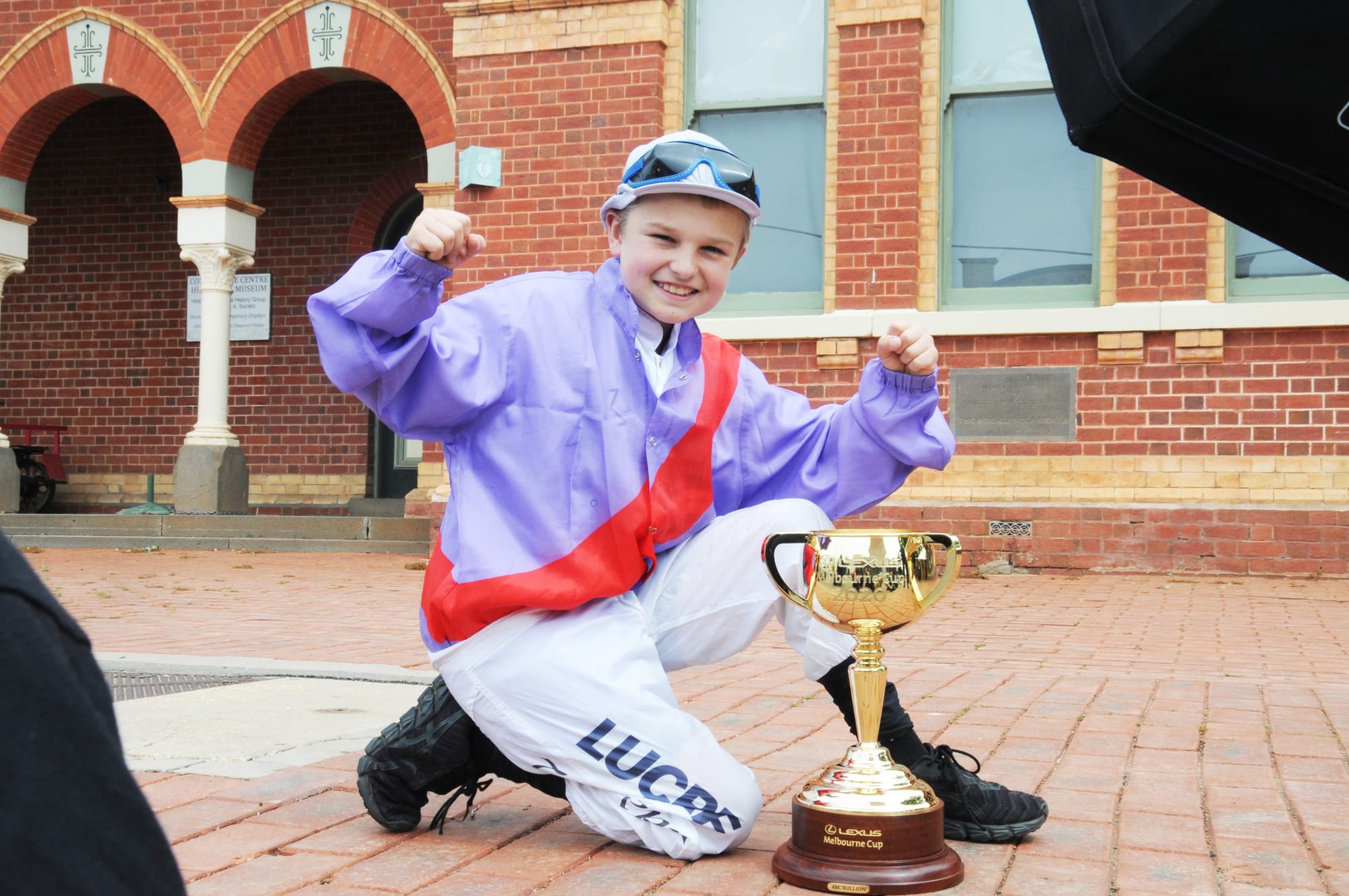 St. Mary’s Primary  School student, Daniel Spencer, nephew of leading Australian jockey, Tommy Berry, and wearing his uncle’s silks, is pictured with the 2020 Lexus Melbourne Cup.