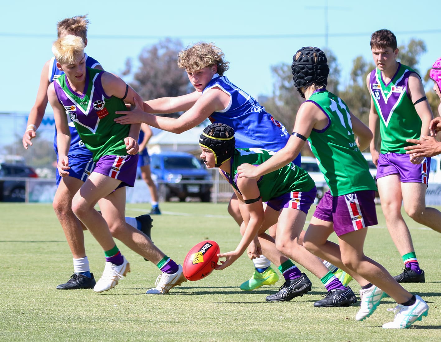 Under-17s. Jack McAuliffe picks up the Sherrin as teammates Austin Dean, Harry Humphreys and Ben Perry provide assistance, while Jesse Lydom and Braxton Hollis apply pressure.