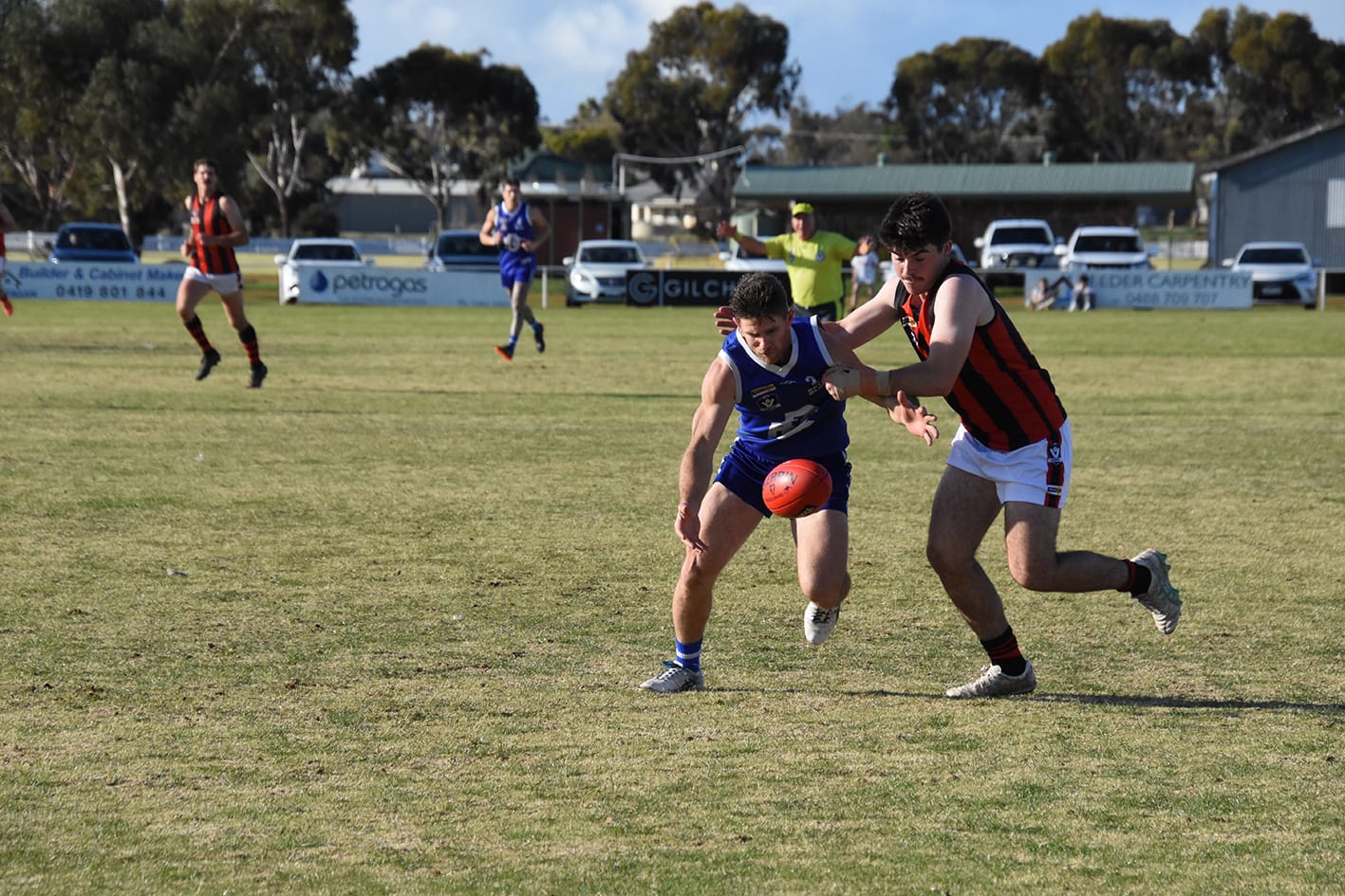 Wedderburn’s Sam Lockhart is doing all he can to stop Donald’s Ryan Hards from getting the Sherrin.