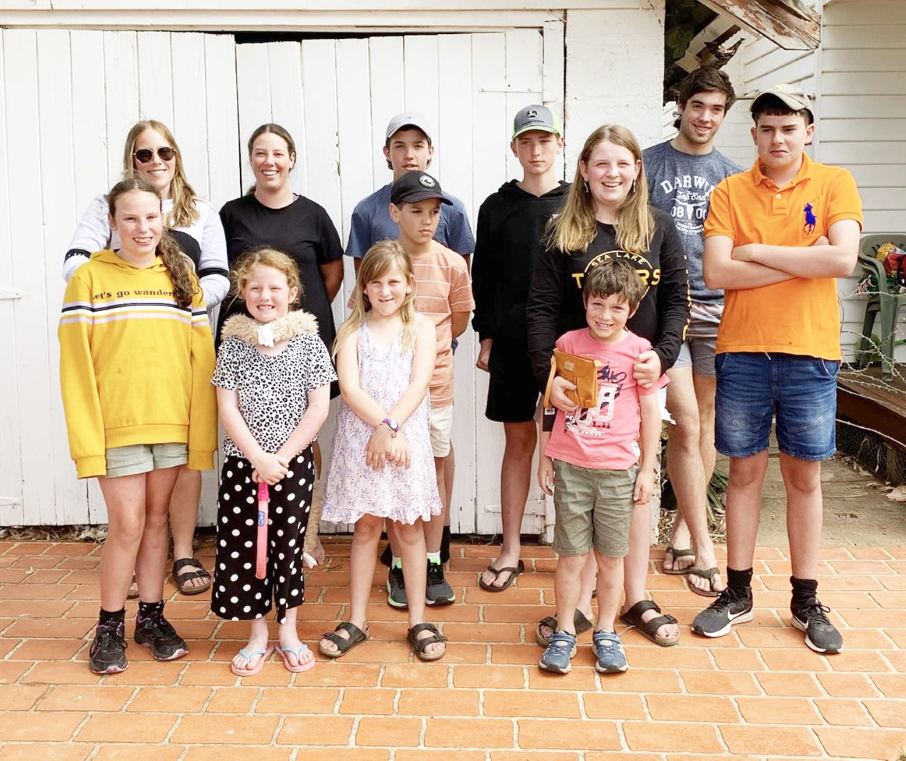 The McClellands, left to right, Georgia, Sophie, Charlie, Lily, Sarah, Nate, Lance, Billy, Rachel, Tom, Drew and Nick Pearce.