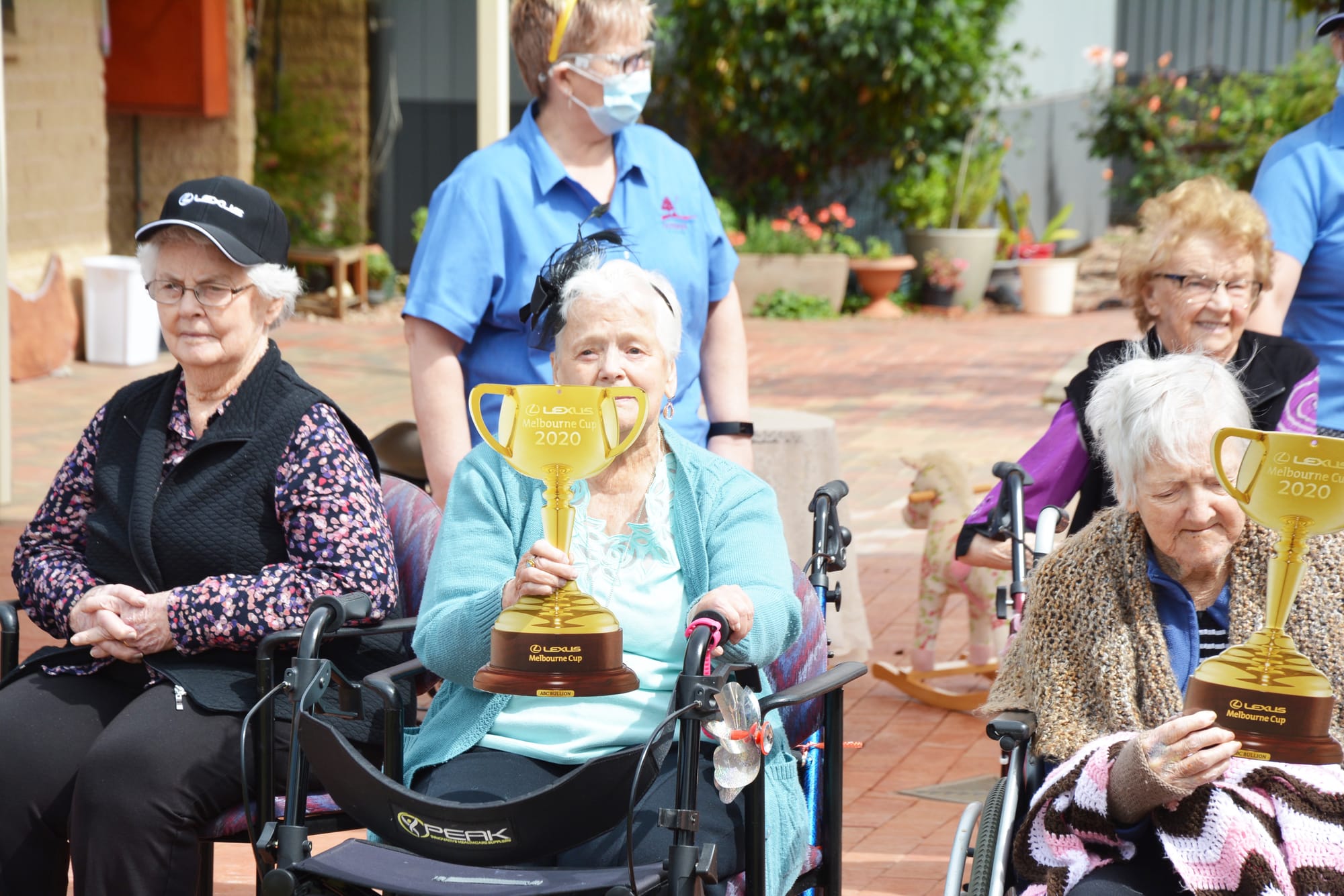 Goodwin Village residents Janice McArthur (with Cup replica), and Therese Brennan. Staff member Trish Anderson is in the background.