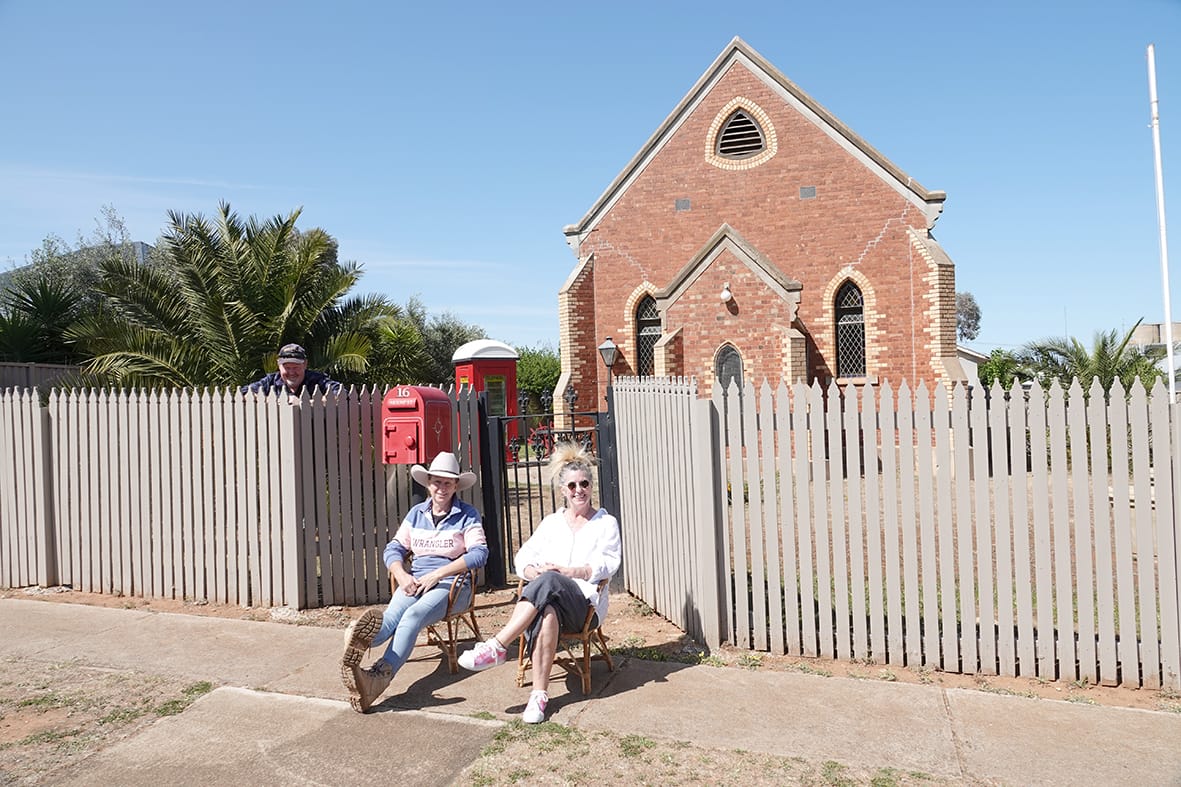 Perfect position for spectating, these two ladies out front of the church-come-residence in are Melissa Waylor on the left and Donna Cherry on the right. (Photo by Jodie Drake.)