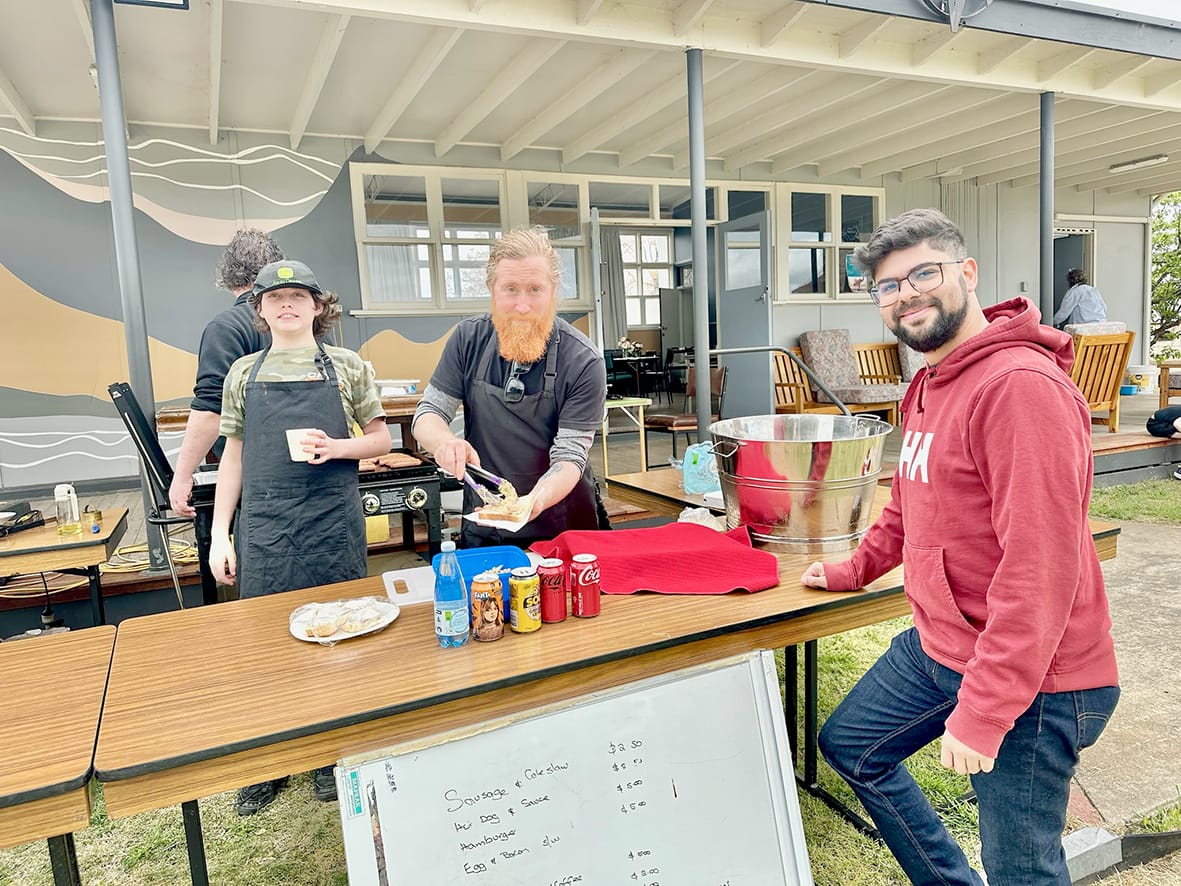 Manning the barbecue for the Good Feed’s sausage sizzle are Ziek Rayner and Ben Bloomfield, with town newcomer Daniel Punetes ready and waiting for his lunch.