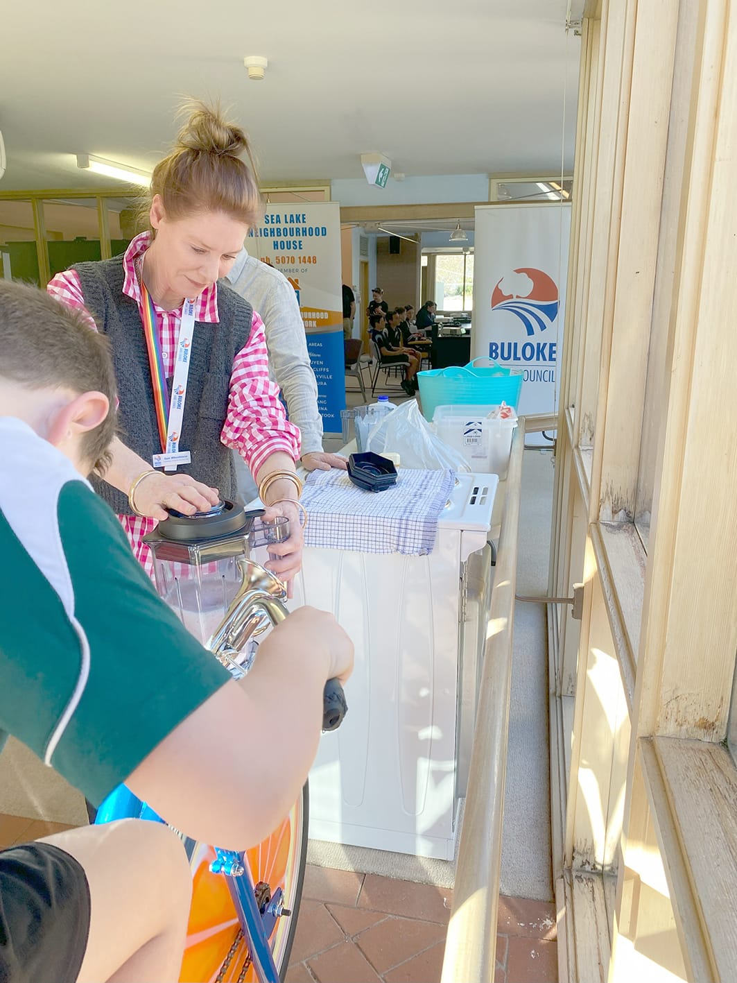 Buloke Shire Council’s Community Recovery Coordinator, Sam Wheelhouse, keeps the pedal-powered smoothie blender steady as one of the young participants uses their leg power to crank out a fresh fruit smoothie.
