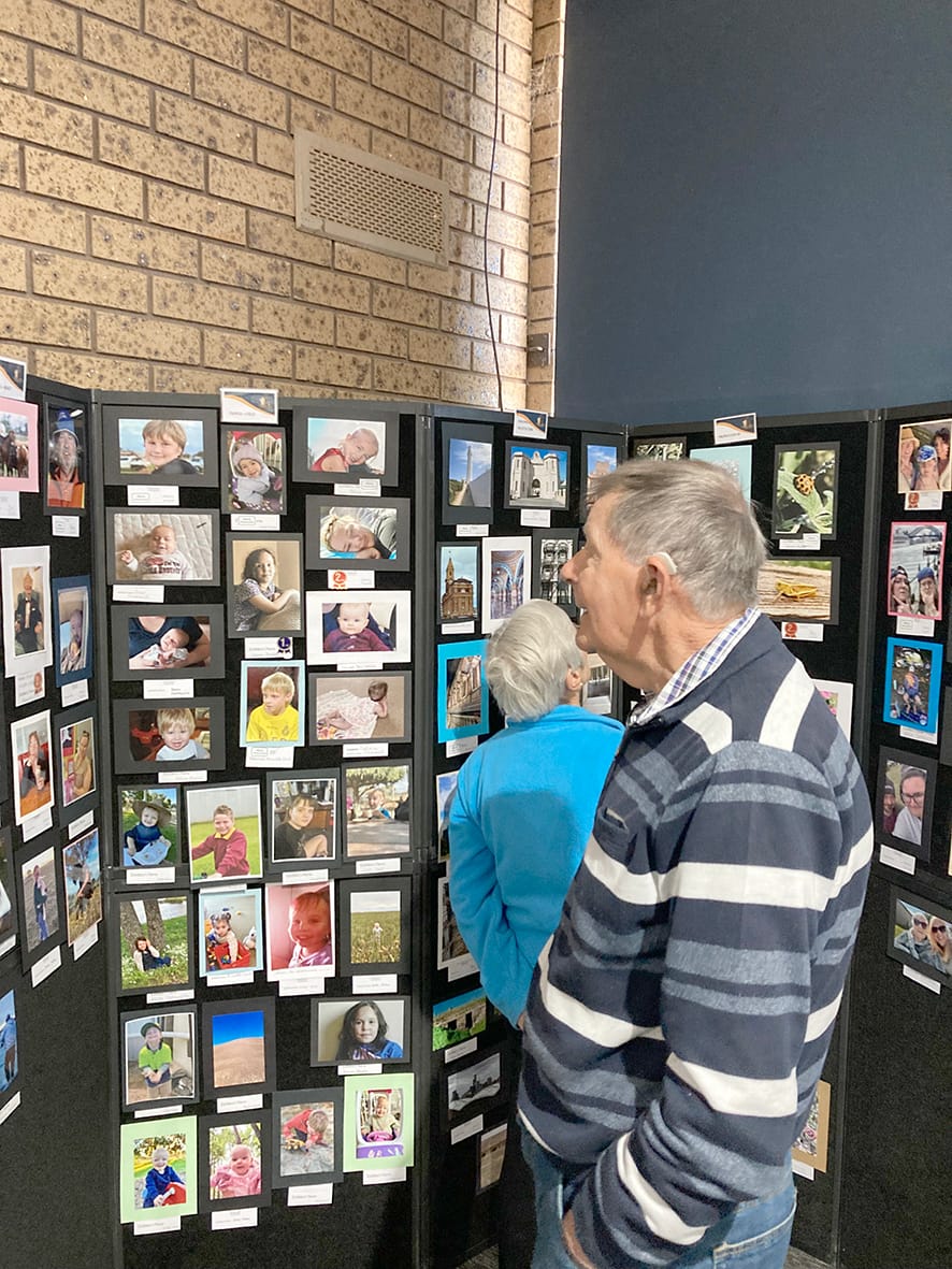 Norm Hollis and Mrs Harris admire the photo entries.