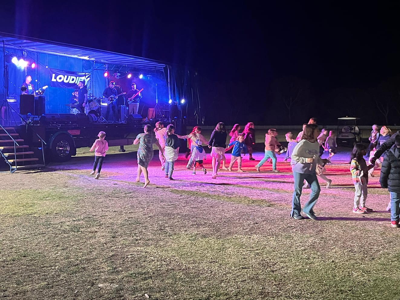 Kids dancing on the lawn while the band “Loudify” entertains prior to the fireworks show.