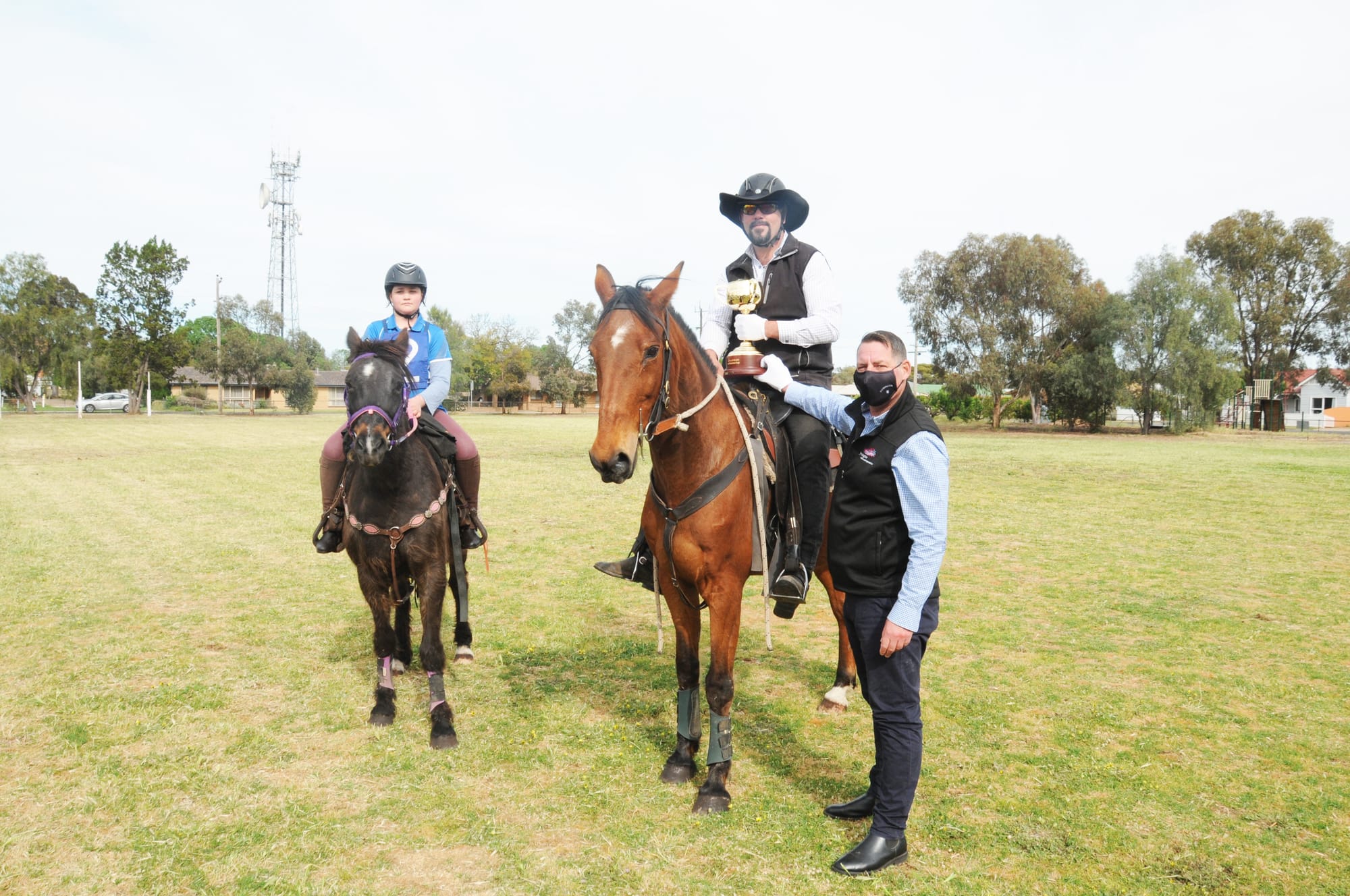 Paul Zielinski and “Jimmy”, receive the 2020 Lexus Melbourne Cup from Melbourne Cup Carnival Security manager, Simon Ogden.