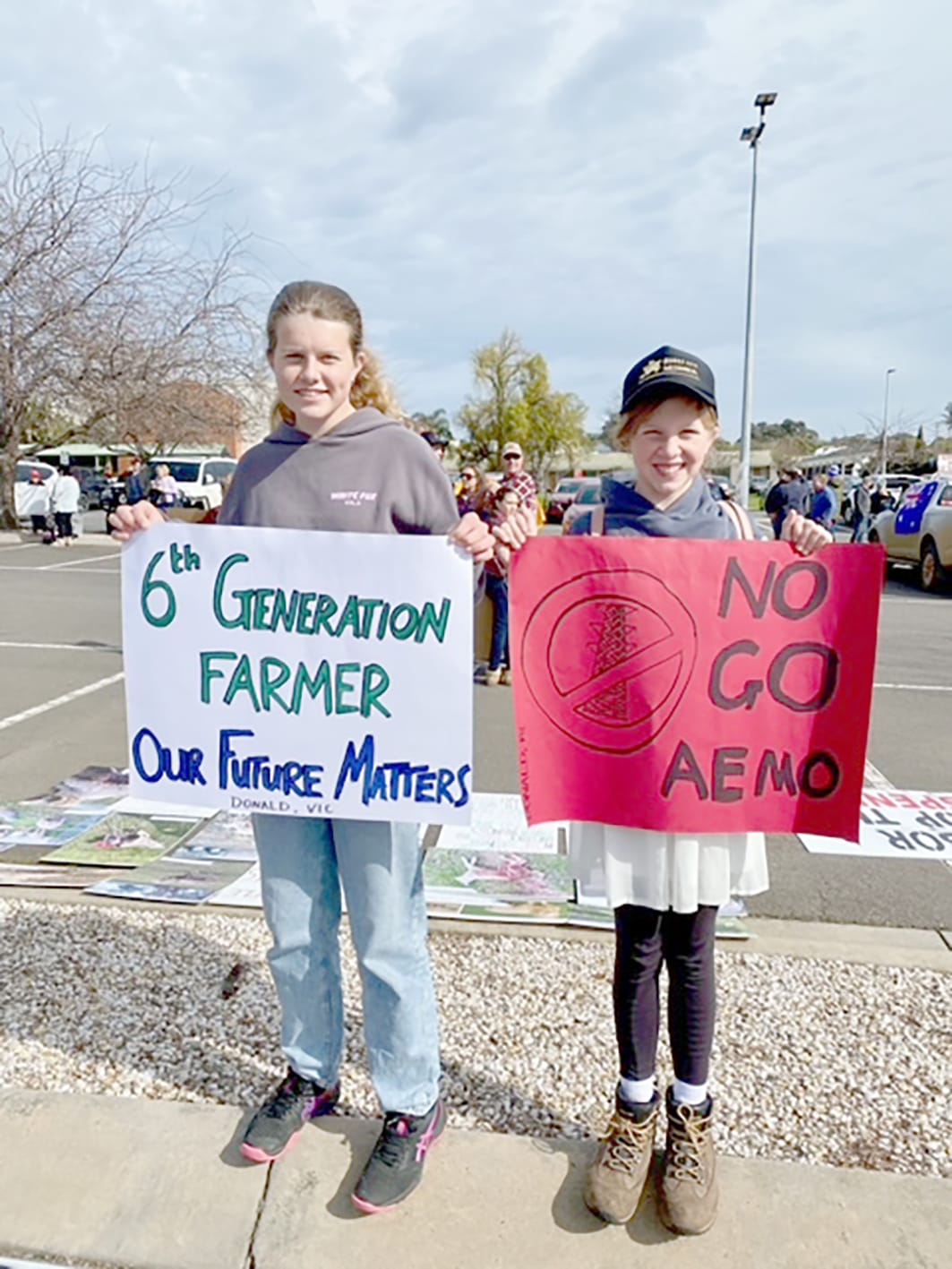 Sophie and Ellie Burke with their signs. (Photo by Susie Burke).