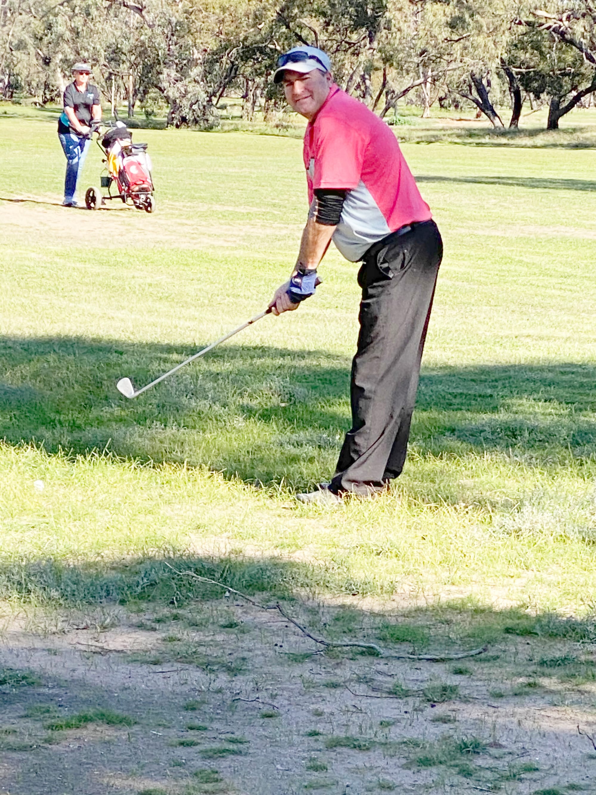 Captain Mark Bowen lines up his approach shot. In the background is Sue Noonan.