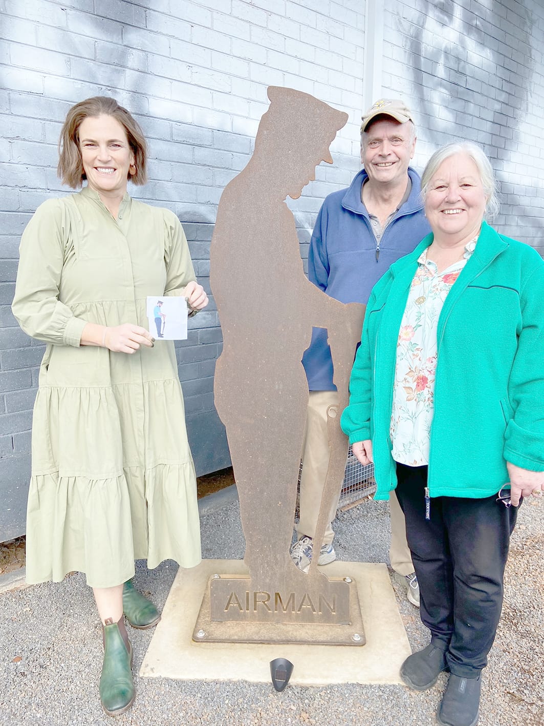 A family affair – Neil and Leonie McGillivray (right) whose son Judd provided the inspiration for the Air Force  figurine, are pictured with Jade Benham, who is holding the photograph of Judd from which the cut-out was created.